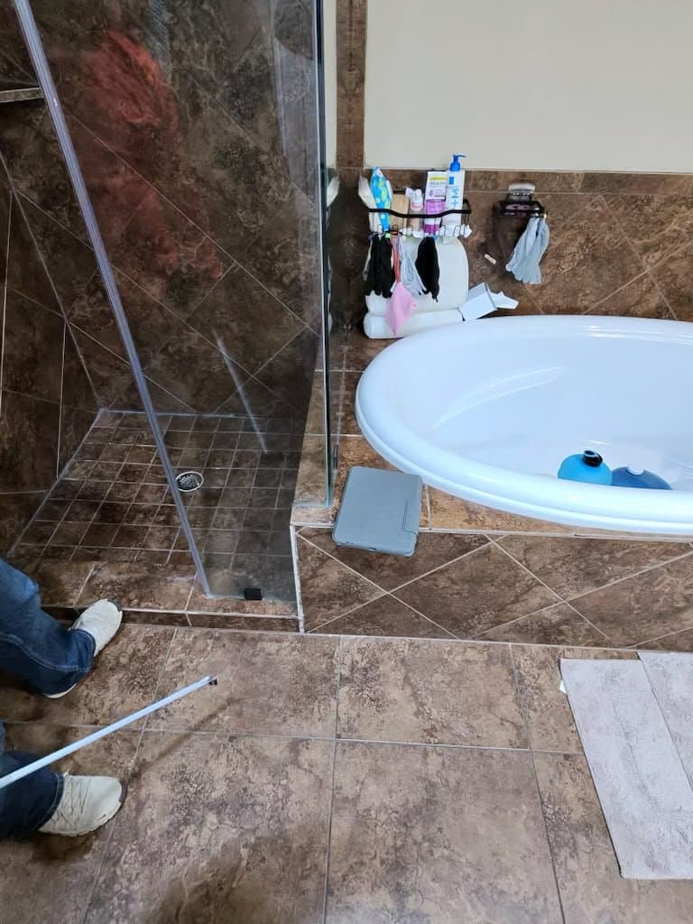 Sonoma Ranch bathroom before — dated brown tile shower and garden tub where grout cracks let water through