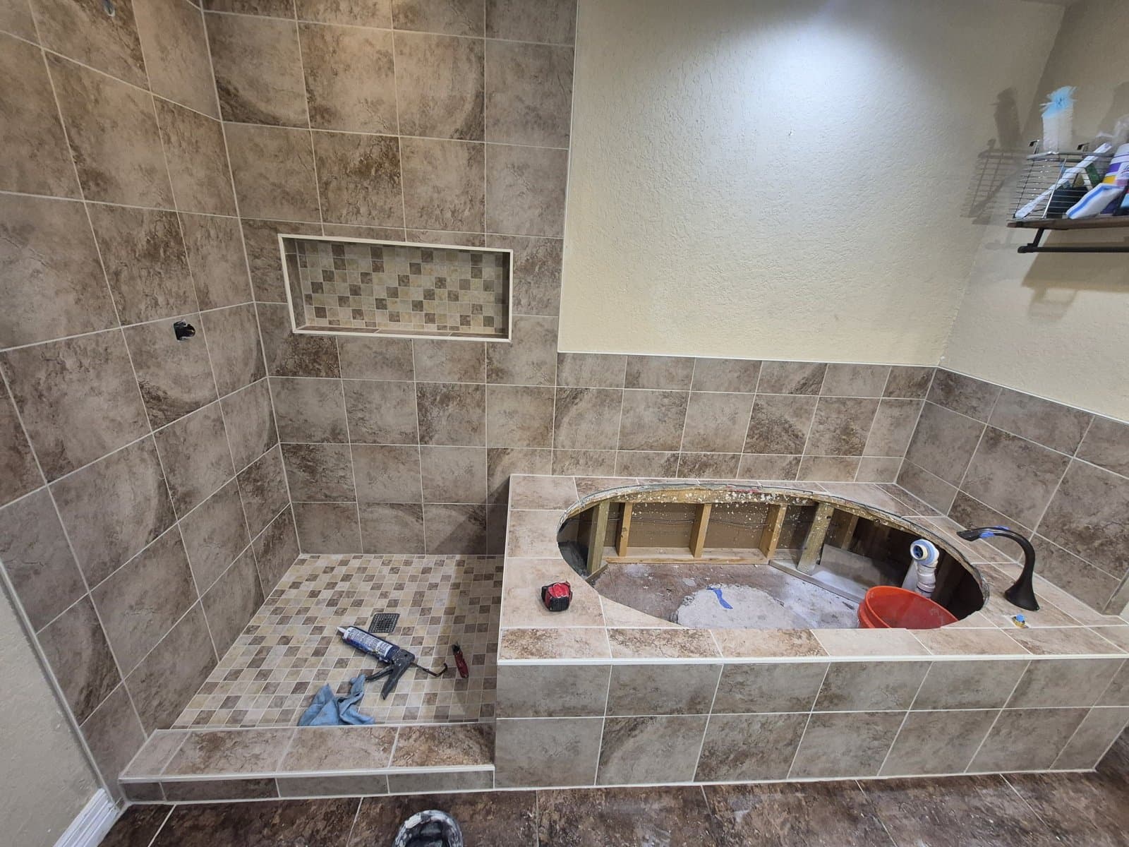 Sonoma Ranch walk-in shower rebuild in progress — new large-format tile, mosaic niche and mosaic pan set