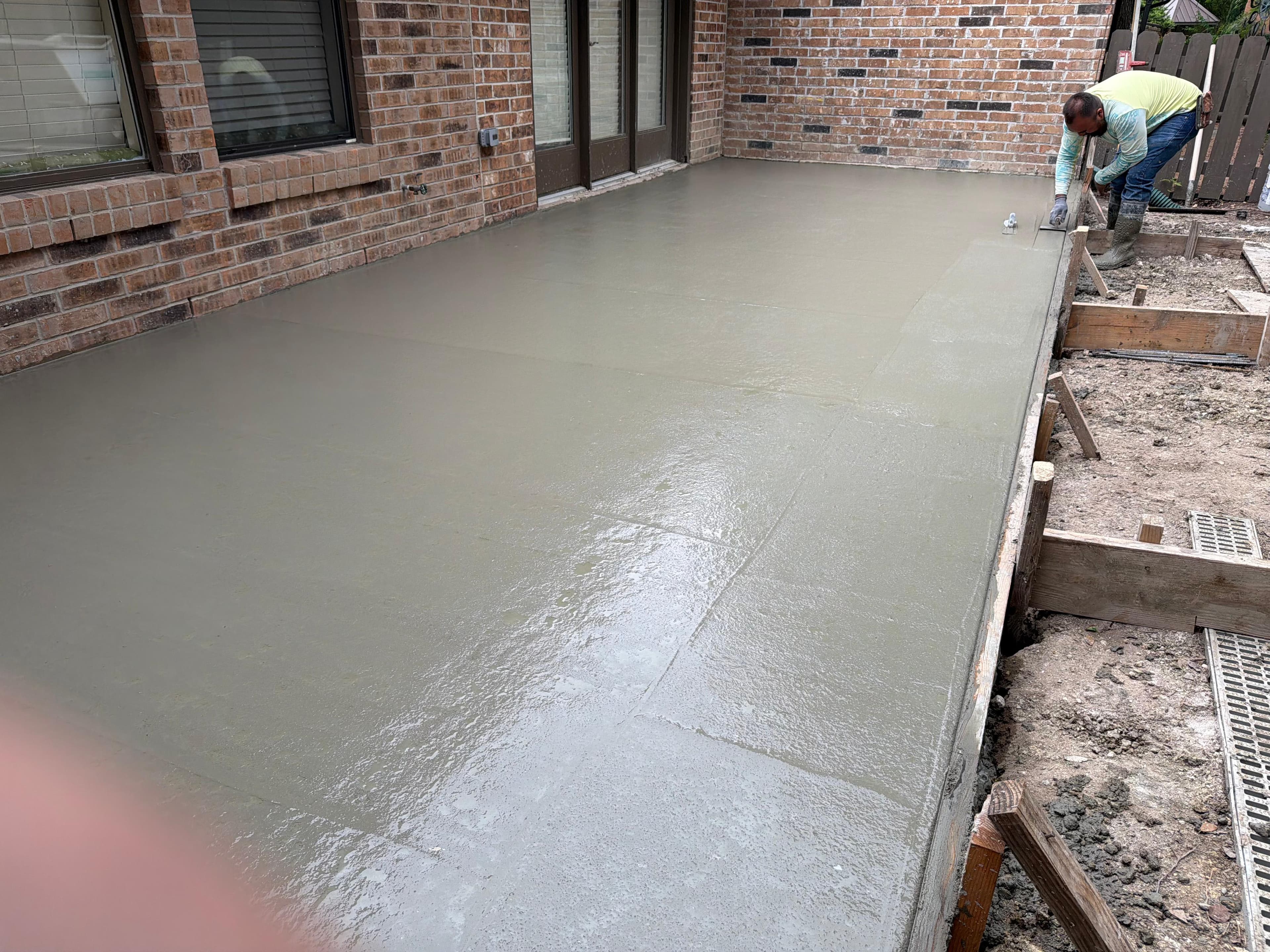 Crew finishing a concrete patio pour, San Antonio TX