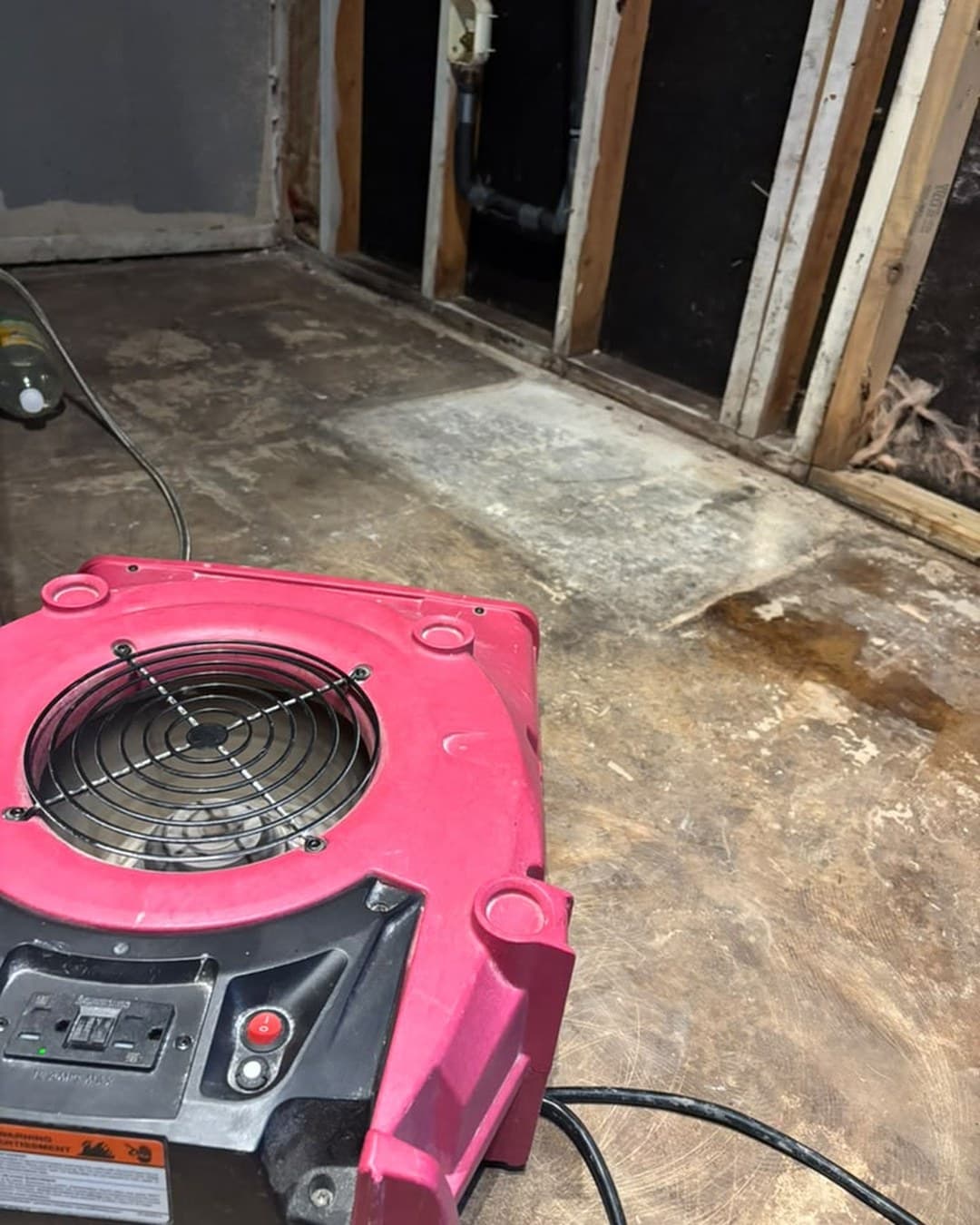Drying equipment running on the bare slab of a Schertz TX kitchen after water damage, by Raging Bull Contracting
