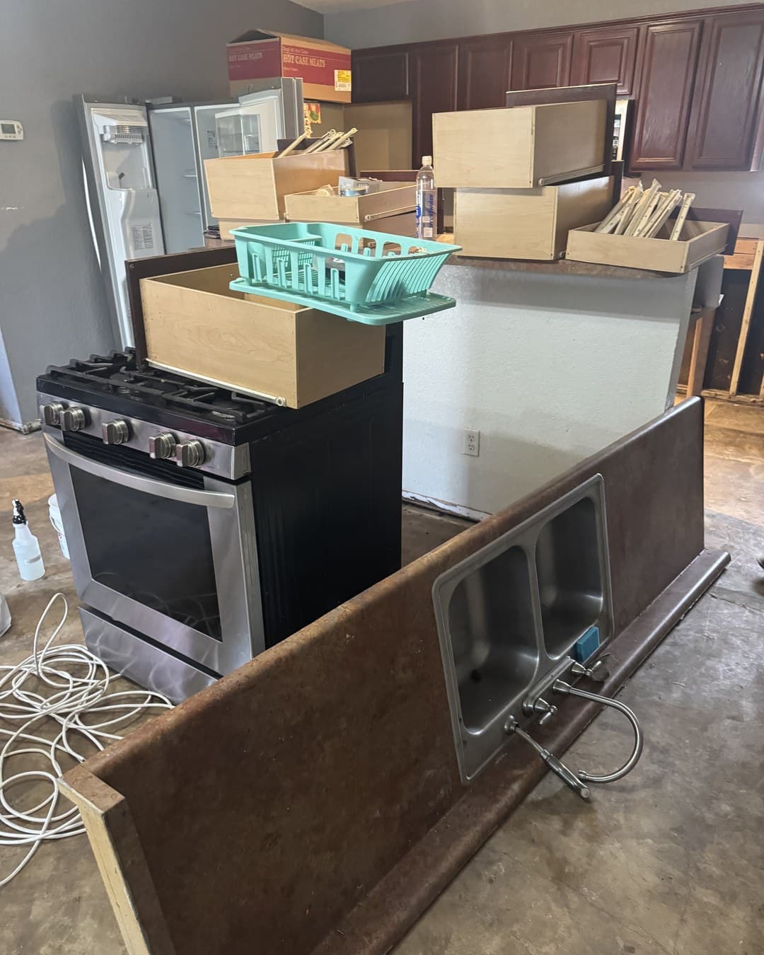 Water-damaged kitchen in Schertz TX stripped back to the slab by Raging Bull Contracting, cabinets and flooring removed